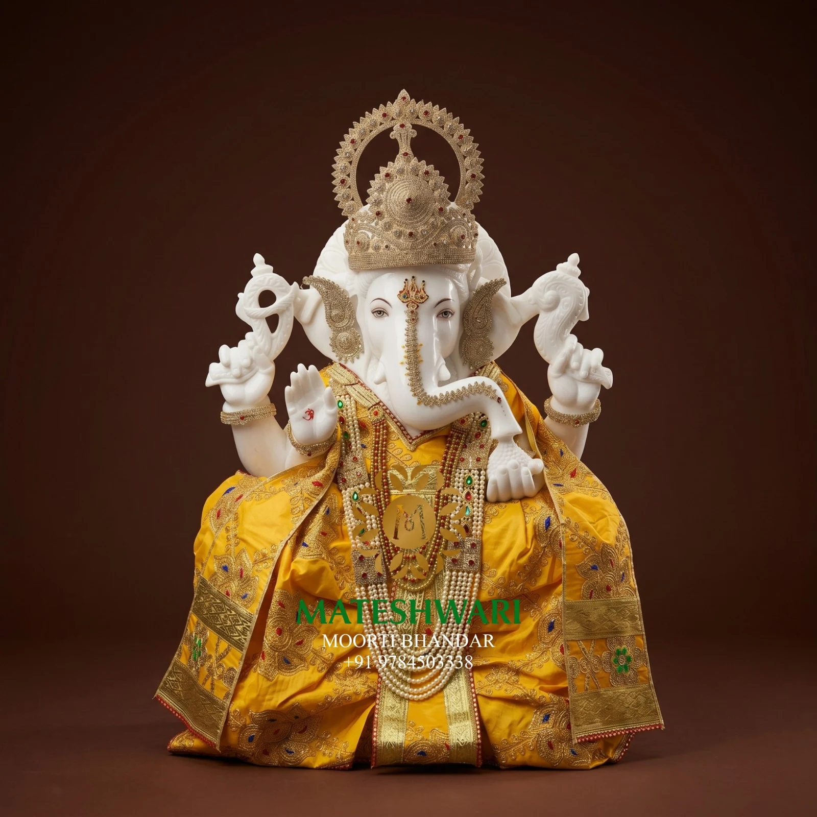 Handcrafted white marble Ganesh murti in yellow attire